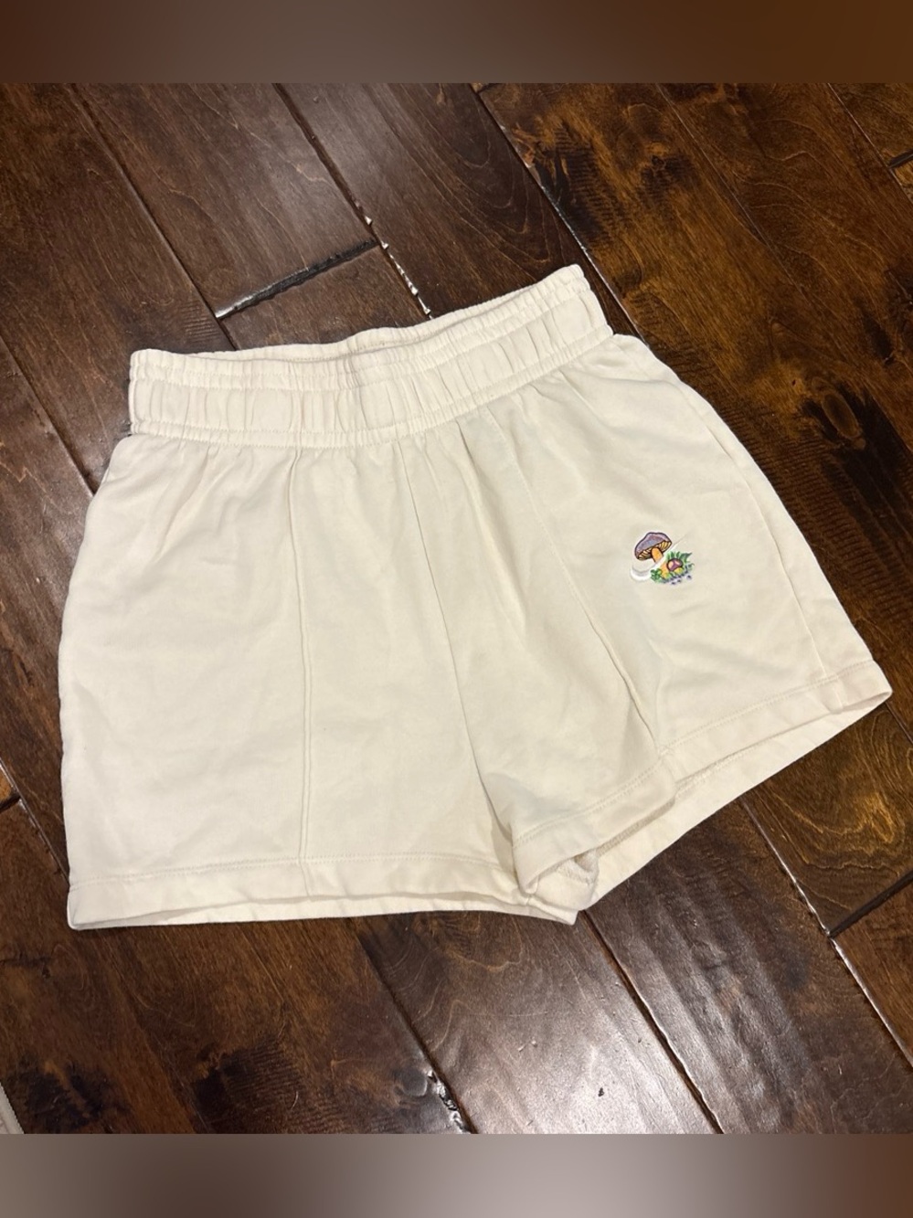 Women’s Nike mushroom embroidered lounge sweat shorts in cream